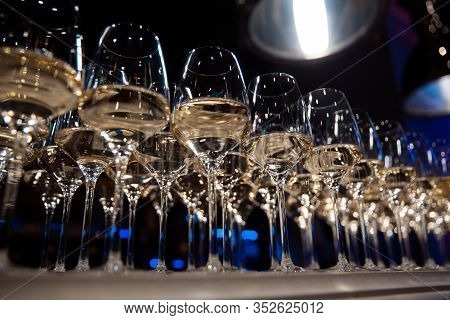 Glasses Of White Wine Are On The Table, Ready To Serve.