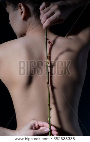 Portrait Of A Young Girl With A Stem Of Thorns Of Roses Behind Her, With A Background On Spinal Prob