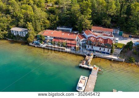 Oyster Farm On The Banks Of The Lima Canal In Croatia. There Are Industrial Buildings, An Embankment