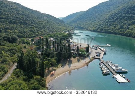 The Lim Bay In Croatia. On The Bank Of The Canal, Among The Trees, There Are Houses And Parking For 