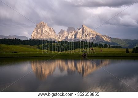 Sassolungo Mountains On The Italian Alps Dolomites With Water Reflection On A Lake