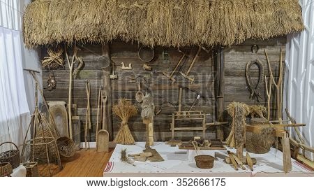 Panoramic View With Old Attributes Of Rural Life. Yarn, Sickle, Seive, Clamp, Log, Saw, Spinning Whe