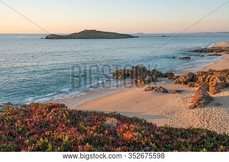 Porto Covo Beach At Sunset With Ilha Do Pessegueiro Island On The Background, In Portugal