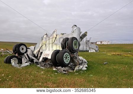 Plane Crash. Parts Of The Destroyed Aircraft, Landing Gear And Fuselage, Lie In The Field