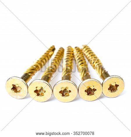 Gold Torx Screw Isolated On White. Yellow Zinc Chipboard Screw Torx, , Full Thread Close Up