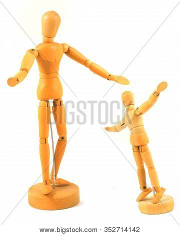 Two Wood Artists Figurines Side By Side In A Welcomed Arms Wide Open Pose While Isolated Over A Whit