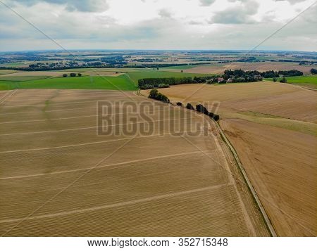 Aerial View Of Small Road Next To Dry Agriculture Field.. Walloon Brabant, Belgium.
