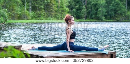 Young Yogi  Girl  Practicing Yoga, Stretching In Monkey God Exercise, Splits, Hanumanasana Pose On T