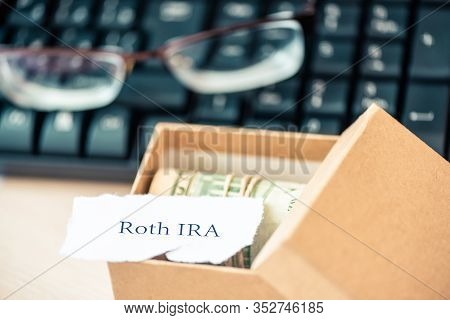 401k Ira Roth On Pieces Of Colorful Paper Dollars On Table. Pension Concept. Retirement Plans.
