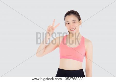 Beautiful Portrait Young Asian Woman In Sport Clothes With Satisfied And Confident Gesture Finger V 