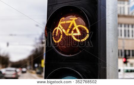 Traffic Light For Cyclists. Yellow Light For Bycicle Lane On A Traffic Light. Traffic Light In Yello
