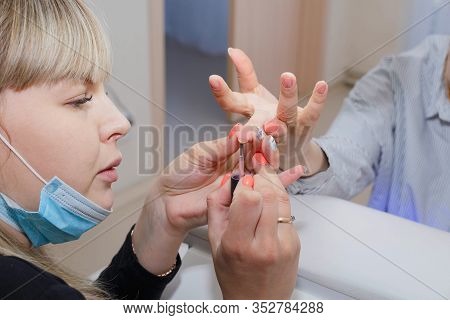 Manicuring Nails - Application Of Base Coat. Selective Focus, High Key