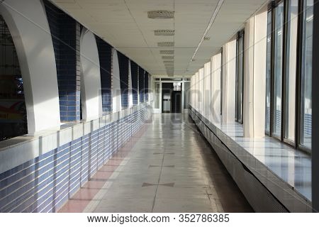 Empty Coridor With Arcs And Sunny Windows In Municipality Building