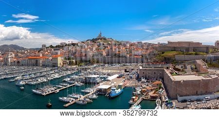 The Old Vieux Port And Basilica Notre Dame De La Garde In The Historical City Center Of Marseilles O