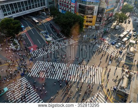 Shibuya, Japan - 23 9 19: People Crossing Shibuya Crossing In The Evening With The Full Crossing In 
