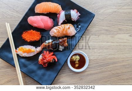 Nigiri Sushi Set With Salmon, Grouper, Eel, Tuna And Prawn On Clay Plates, Flat Lay. Delicious Tradi
