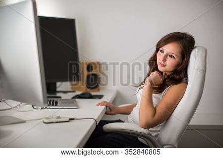 Woman working on a computer in a home office