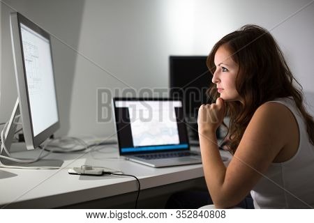 Woman working on a computer in a home office