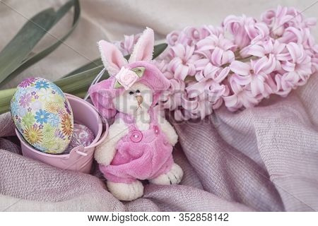 Easter Rubbit In A Natural Birds Nest With Chocolate Easter Eggs Next To E Spring Flower. Home Easte