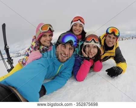 Group Of Friends With Equipment Taking Selfie At Ski Resort. Winter Vacation