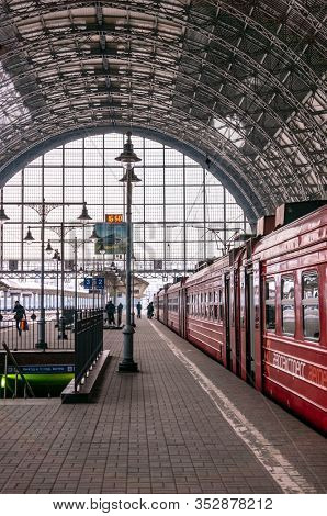 Moscow, Russia - March 23, 2013: Covered platform of Kievsky railway station. Red train aeroexpress to airport. People on the platform beside the Aero express train at Kievsky railway station Moscow