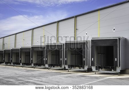Warehouse Loading Docks On A Sunny Day. Open Gates Of An Industrial Warehouse. Storehouse Doors In A