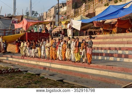 Varanasi, India - March 17, 2019: Young Hindu Priests On Ghats In Morning