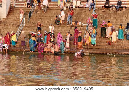 Varanasi, India - March 18, 2019: People Bathing In Water Holy Ganga River At Kedar Ghat In Morning