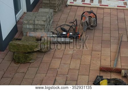 Concrete Drilling With Industrial Boring Machine Next To It Is A Stone Cutting Saw