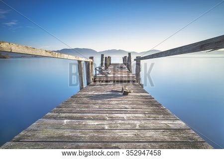 Wooden Pier Or Jetty And Lake At Sunrise. Long Exposure. Torre Del Lago Puccini, Versilia, Massaciuc