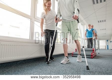 People in rehabilitation learning how to walk with crutches after having had an injury