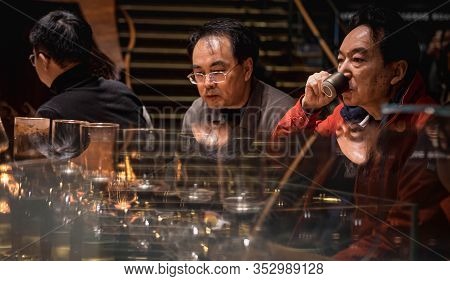 Shanghai, China - January 11, 2020: Unsprcific Man Is Dringing Coffee At The Starbucks Reserve Roast