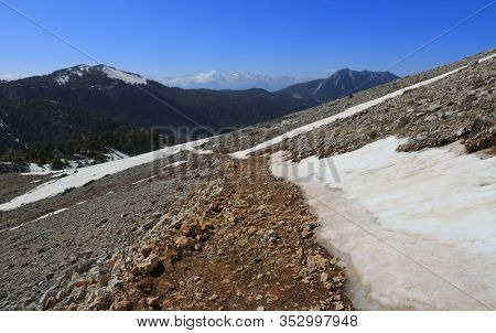landscape with pathway in mountains among snow and stones. Take it in Turkey on Likya Yolu tourist walkway