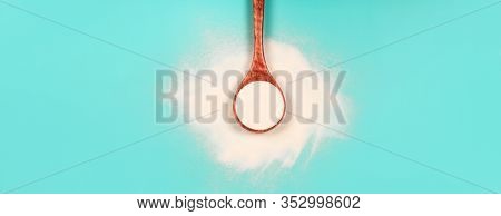Banner With Wooden Spoon Of Collagen Or Protein In Powder On Teal Background. Flat Lay Style. Beauty