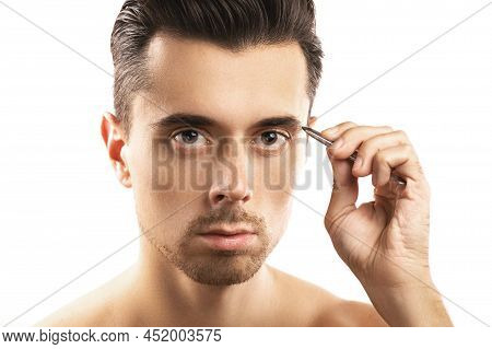Young Guy Holding Tweezers Near His Eyebrow For Thats Shape Correction