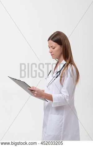 Fimale Medical Doctor Holding A Folder Isolated On White