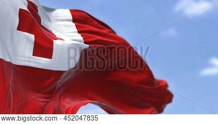 Detail Of The National Flag Of Tonga Waving In The Wind On A Clear Day. Tonga Is A Polynesian Countr
