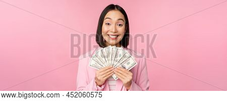 Finance, Microcredit And People Concept. Happy Smiling Asian Businesswoman Showing Dollars Money, St