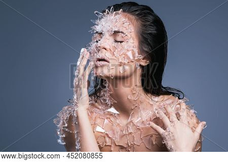 Female Face Covered With A Lot Small Pieces Of Glass Or Ice