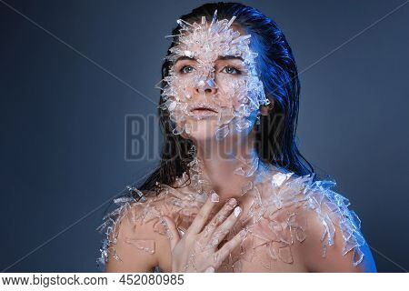 Female Face Covered With A Lot Small Pieces Of Glass Or Ice
