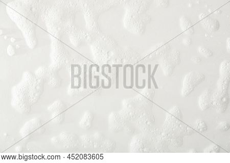 Foam Texture On A White Base With Traces Of Soap And Shower Water. Top View. Horizontal Composition.