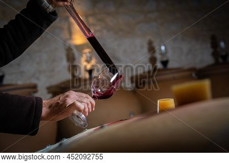 France, Gironde, Saint-emilion, Sampling A Glass Of Wine In A Barrel With A Pipette For Tasting And 