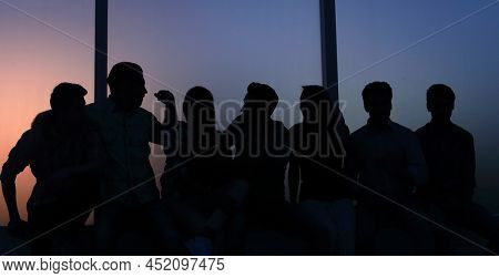 group of creative youth looks through the office windo