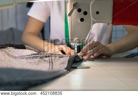 Hands Of A Seamstress Working For The Machine.close Up