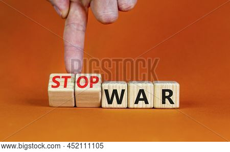 Stop War Symbol. Businessman Turns Cubes And Changes Concept Words War To Stop War. Beautiful Orange