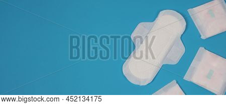 Woman Sanitary Napkins On Blue Background. Top View.
