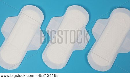 Woman Sanitary Napkins On Blue Background. Top View.