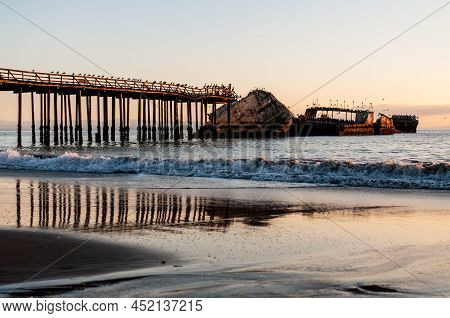 A Beautiful Sunset Over The Beach Near Aptos, California, Highlighting The Old Derelict Pier And An 