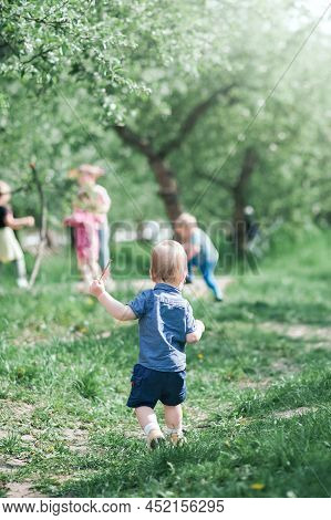 Toddler Eggs Hunters Close-up. Children Activity For Easter In Nature.