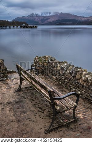 Stunning Landscape Image Of Loch Lomond And Snowcapped Mountain Range In Distance Viewed From Small 